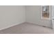 This empty bedroom has carpeted floors, white walls, and a window at 25 Basil Ct, Franklinton, NC 27525