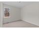 This empty carpeted bedroom features a window and white walls at 25 Basil Ct, Franklinton, NC 27525