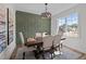 Dining room with decorative trim accent wall, dining table set, chandelier, and natural light from the window at 25 Basil Ct, Franklinton, NC 27525