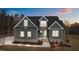 Two-story craftsman home with gray siding, landscaping, and a light gray door at 25 Basil Ct, Franklinton, NC 27525