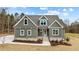 New construction home with gray siding, stone accents, and a front porch at 25 Basil Ct, Franklinton, NC 27525