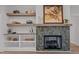 Living room fireplace with tile surround, built-in shelves and a wood mantle at 25 Basil Ct, Franklinton, NC 27525