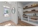 Bright foyer featuring wood-look flooring, a decorative mirror, and open shelving for décor at 25 Basil Ct, Franklinton, NC 27525