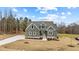 Front exterior of a green home featuring a long driveway and neatly landscaped front yard at 25 Basil Ct, Franklinton, NC 27525
