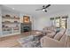 Comfortable living room with a fireplace, stylish ceiling fan, and a cozy seating arrangement at 25 Basil Ct, Franklinton, NC 27525