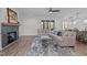 Bright living room featuring a fireplace, window to porch, hardwood floors and modern decor at 25 Basil Ct, Franklinton, NC 27525
