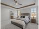 This main bedroom features a ceiling fan, natural light, and a view into the bathroom at 25 Basil Ct, Franklinton, NC 27525