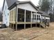 Spacious screened porch with wooden deck and black railings, overlooking the backyard at 1226 Red Cedar Ct, Youngsville, NC 27596