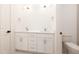 Bright bathroom featuring a double sink vanity with white cabinets and modern fixtures at 1226 Red Cedar Ct, Youngsville, NC 27596