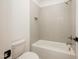 Tiled bathroom with shower-tub combo, featuring gray subway tiles and chrome fixtures at 1226 Red Cedar Ct, Youngsville, NC 27596