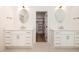 Bathroom featuring dual vanities with bronze hardware and a walk-in closet at 1226 Red Cedar Ct, Youngsville, NC 27596