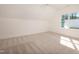 Bright, carpeted bedroom with natural light from a large window and modern ceiling fan at 1226 Red Cedar Ct, Youngsville, NC 27596