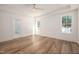 Bright, neutral bedroom featuring light hardwood floors and large windows at 1226 Red Cedar Ct, Youngsville, NC 27596