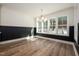 Bright dining area boasts natural light, elegant chandelier, and views of the snowy landscape through large windows at 1226 Red Cedar Ct, Youngsville, NC 27596