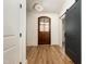 Inviting entryway featuring stylish plank flooring, a decorative front door, and a modern sliding barn door at 1226 Red Cedar Ct, Youngsville, NC 27596