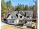 Two-story brick and siding home with black mulch landscaping, a gray roof, and a large front yard at 1226 Red Cedar Ct, Youngsville, NC 27596