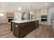 Open concept kitchen with a large island, stainless steel appliances, and direct access to the living room at 1226 Red Cedar Ct, Youngsville, NC 27596