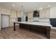 Gourmet kitchen with a large center island, pendant lighting, custom cabinets, and stainless steel appliances at 1226 Red Cedar Ct, Youngsville, NC 27596