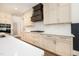 Modern kitchen featuring quartz countertops, white subway tile backsplash, and custom cabinetry with gold hardware at 1226 Red Cedar Ct, Youngsville, NC 27596