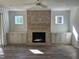 Cozy living room featuring a brick fireplace and built-in shelving at 1226 Red Cedar Ct, Youngsville, NC 27596