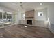 Beautiful living room with a brick fireplace, built-in cabinets, ceiling fan, and sliding door to the patio at 1226 Red Cedar Ct, Youngsville, NC 27596