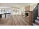 Bright living room features a brick fireplace, hardwood floors, and sliding doors to the outdoor space at 1226 Red Cedar Ct, Youngsville, NC 27596