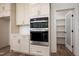 Modern white kitchen cabinets and stainless steel appliances at 1226 Red Cedar Ct, Youngsville, NC 27596