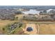 An aerial view of a modern home near a lake, surrounded by trees and other luxury houses at 30 Hartwood Ln, Youngsville, NC 27596