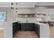 Entertainer's bar area with a wine fridge, marble countertops, storage, and easy access to the open-concept kitchen at 30 Hartwood Ln, Youngsville, NC 27596