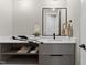 Modern bathroom vanity with marble countertop, a rectangular mirror, and a white flower decor at 30 Hartwood Ln, Youngsville, NC 27596