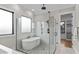 Luxurious bathroom featuring a soaking tub, separate glass-enclosed shower, and modern fixtures at 30 Hartwood Ln, Youngsville, NC 27596
