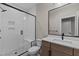 Bathroom featuring white subway tile shower with glass door, wood vanity, and black hardware at 30 Hartwood Ln, Youngsville, NC 27596