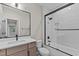 Bathroom featuring white subway tile shower and tub combo, wood vanity, and black hardware at 30 Hartwood Ln, Youngsville, NC 27596