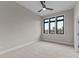 Bedroom with neutral carpet, trim, black framed windows and a ceiling fan at 30 Hartwood Ln, Youngsville, NC 27596