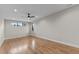 Open bedroom with hardwood floors, recessed lighting, and natural light from the window at 30 Hartwood Ln, Youngsville, NC 27596