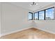 Empty bedroom featuring hardwood floors, neutral walls, trim and windows offering natural light at 30 Hartwood Ln, Youngsville, NC 27596