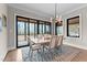 Elegant dining room with natural light, modern chandelier, neutral decor, and seamless access to outdoor living space at 30 Hartwood Ln, Youngsville, NC 27596