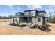 Beautiful two-story home featuring stone accents, a covered porch, manicured landscaping, and ample curb appeal at 30 Hartwood Ln, Youngsville, NC 27596