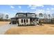 Eye-catching two-story home with a three-car garage, stone accents, professional landscaping, and a concrete driveway at 30 Hartwood Ln, Youngsville, NC 27596