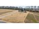 A landscaped yard surrounds this two-story home with a long driveway leading to a modern style home at 30 Hartwood Ln, Youngsville, NC 27596
