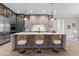 Modern kitchen showcasing an island with seating, pendant lighting, stainless steel appliances, and custom cabinets at 30 Hartwood Ln, Youngsville, NC 27596