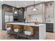 Stylish kitchen with a waterfall island, pendant lighting, stainless steel appliances, and custom cabinetry at 30 Hartwood Ln, Youngsville, NC 27596