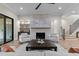 Bright living room featuring a stone fireplace, hardwood floors, and elegant seating arrangement at 30 Hartwood Ln, Youngsville, NC 27596