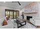 Cozy living room with a stone fireplace, built-in shelving, neutral decor, and seamless access to the outdoor patio at 30 Hartwood Ln, Youngsville, NC 27596