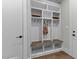 Mudroom with a built-in storage unit that includes shelving, hooks, a bench, and lower storage compartments at 30 Hartwood Ln, Youngsville, NC 27596