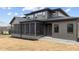 The home's rear exterior featuring the screened-in porch and neutral color palette is ideal for backyard gatherings at 30 Hartwood Ln, Youngsville, NC 27596