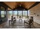 Stunning screened-in porch featuring wood ceilings, stone fireplace, comfortable seating, and scenic views at 30 Hartwood Ln, Youngsville, NC 27596