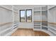 Spacious walk-in closet with built-in shelving and a window for natural light at 30 Hartwood Ln, Youngsville, NC 27596