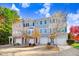 Three-unit townhome building with attached garages and autumn landscaping at 3118 Courtney Creek Blvd, Durham, NC 27713