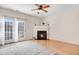 Living room with fireplace, hardwood floors, and access to a patio at 3118 Courtney Creek Blvd, Durham, NC 27713